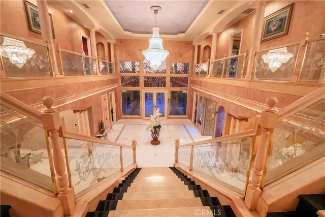 a living room with furniture and a chandelier