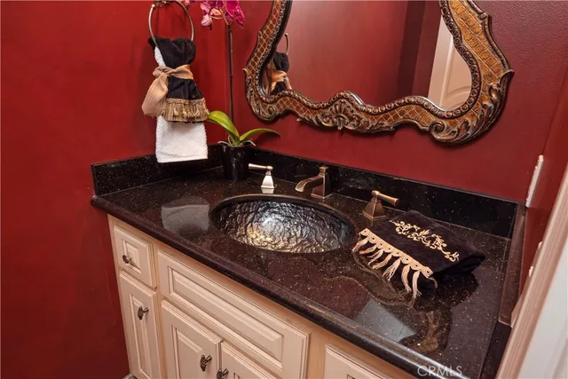 a view of a swimming pool with a lawn chairs and palm trees