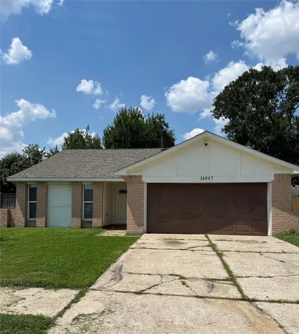 a front view of a house with a yard and a garage