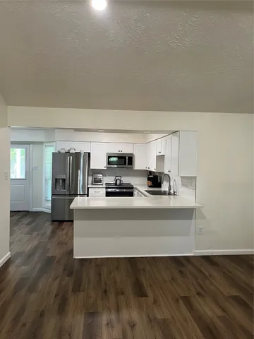a view of an empty room and fire place