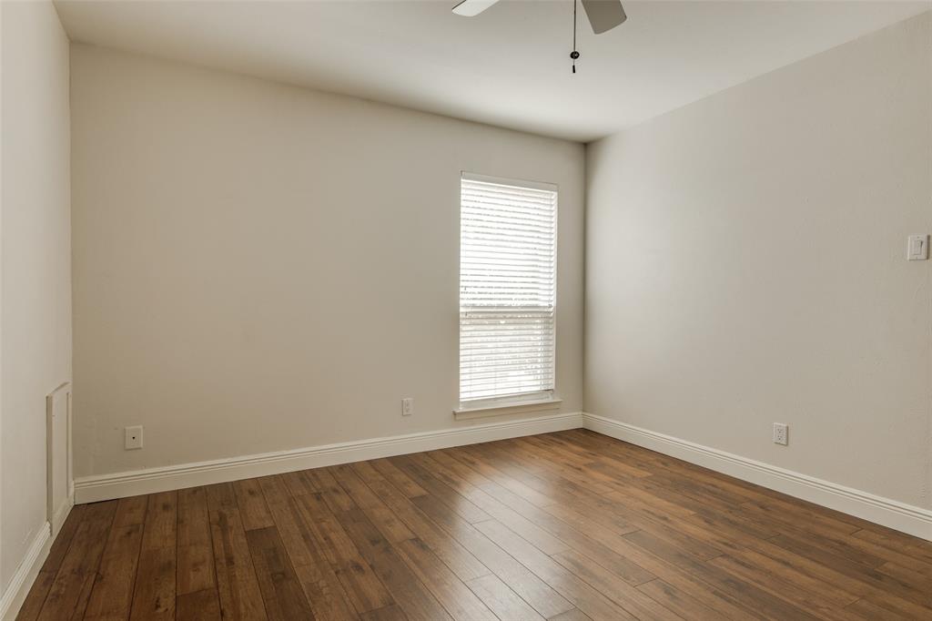 3907 Gilbert Avenue, Unit 8 Dallas, TX 75219 - Photo 6 of 11 an empty room with wooden floor and windows