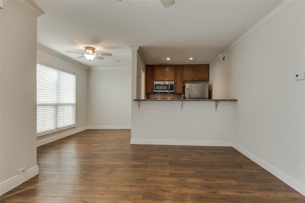3907 Gilbert Avenue, Unit 8 Dallas, TX 75219 - Photo 10 of 11 an empty room with wooden floor and windows