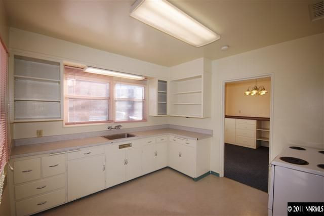 195 Booth Street Reno, NV 89509 - Photo 8 of 13 a kitchen with granite countertop white cabinets and white appliances