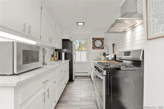 a kitchen with stainless steel appliances granite countertop a stove and a sink
