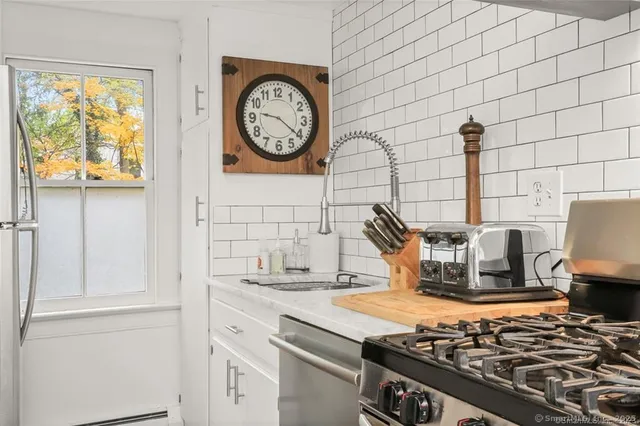 a kitchen with a stove and a clock