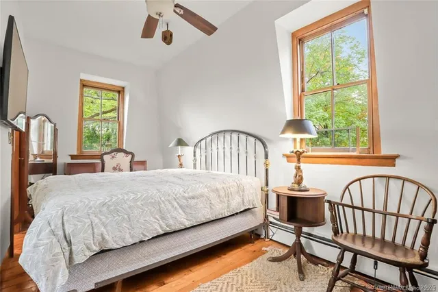a bedroom with a bed chair and a window