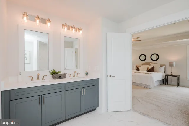 a en suite bathroom with a tub sink and mirror