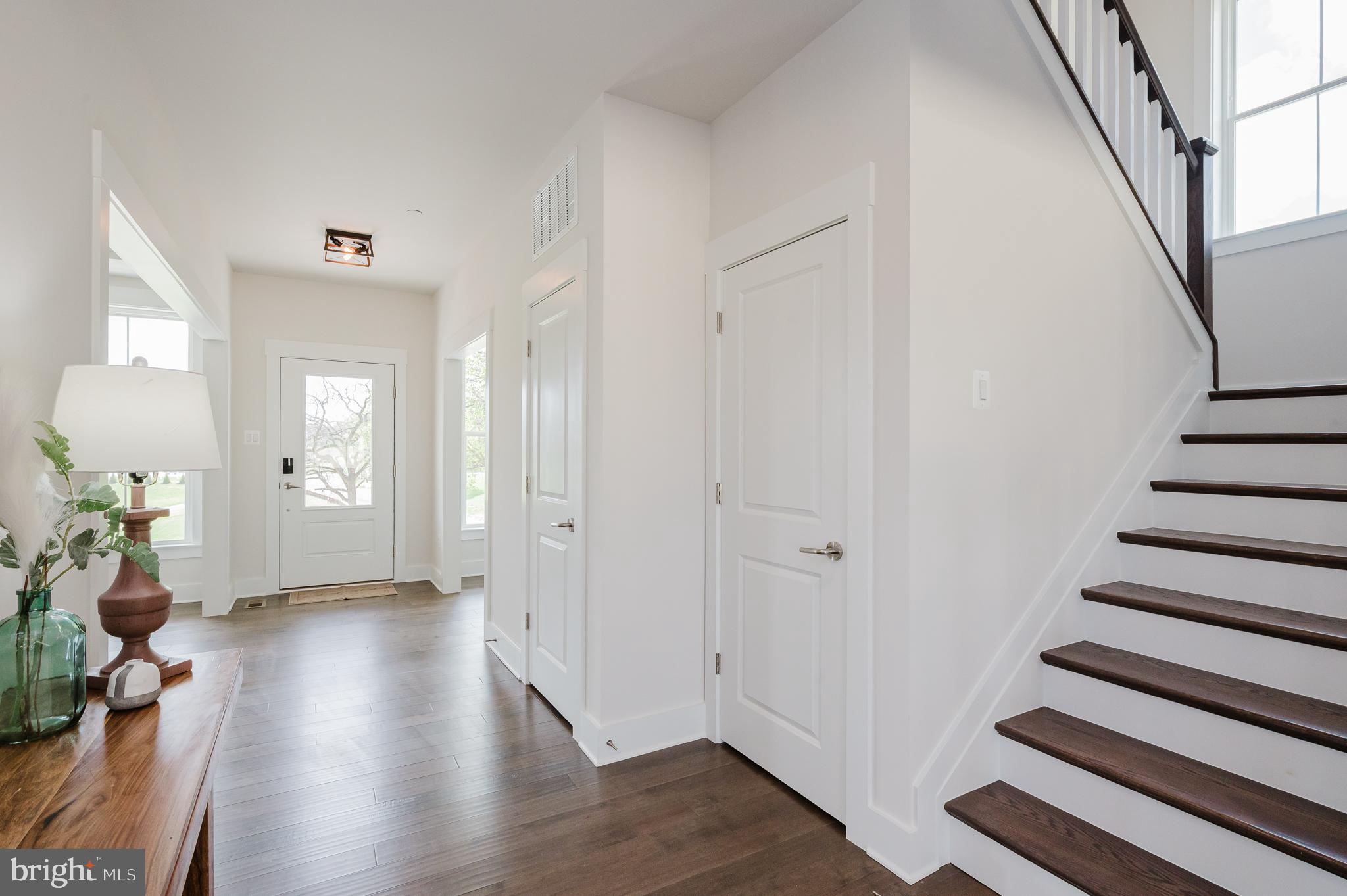 5725 Hodges Road Sykesville, MD 21784 - Photo 20 of 56 a view of a hallway with wooden floor and stairs