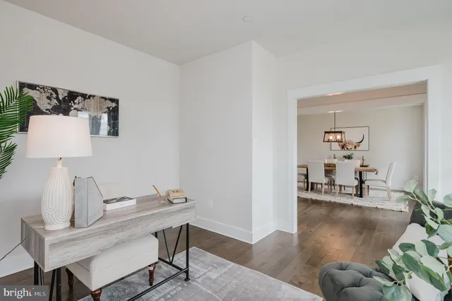 a dining room with furniture a chandelier and wooden floor