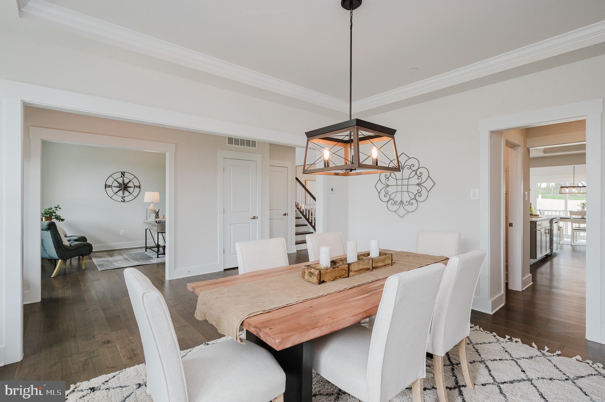5725 Hodges Road Sykesville, MD 21784 - Photo 24 of 56 a view of a dining room with furniture wooden floor and a chandelier
