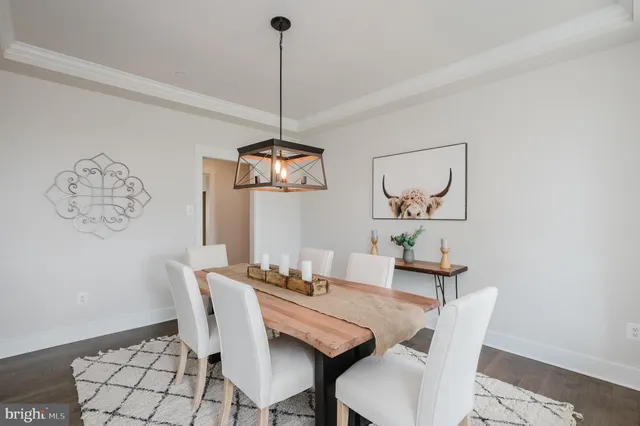 a view of a dining room with furniture wooden floor and a chandelier