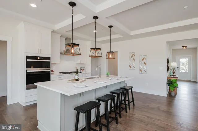 a view of a dining room with furniture a chandelier and wooden floor