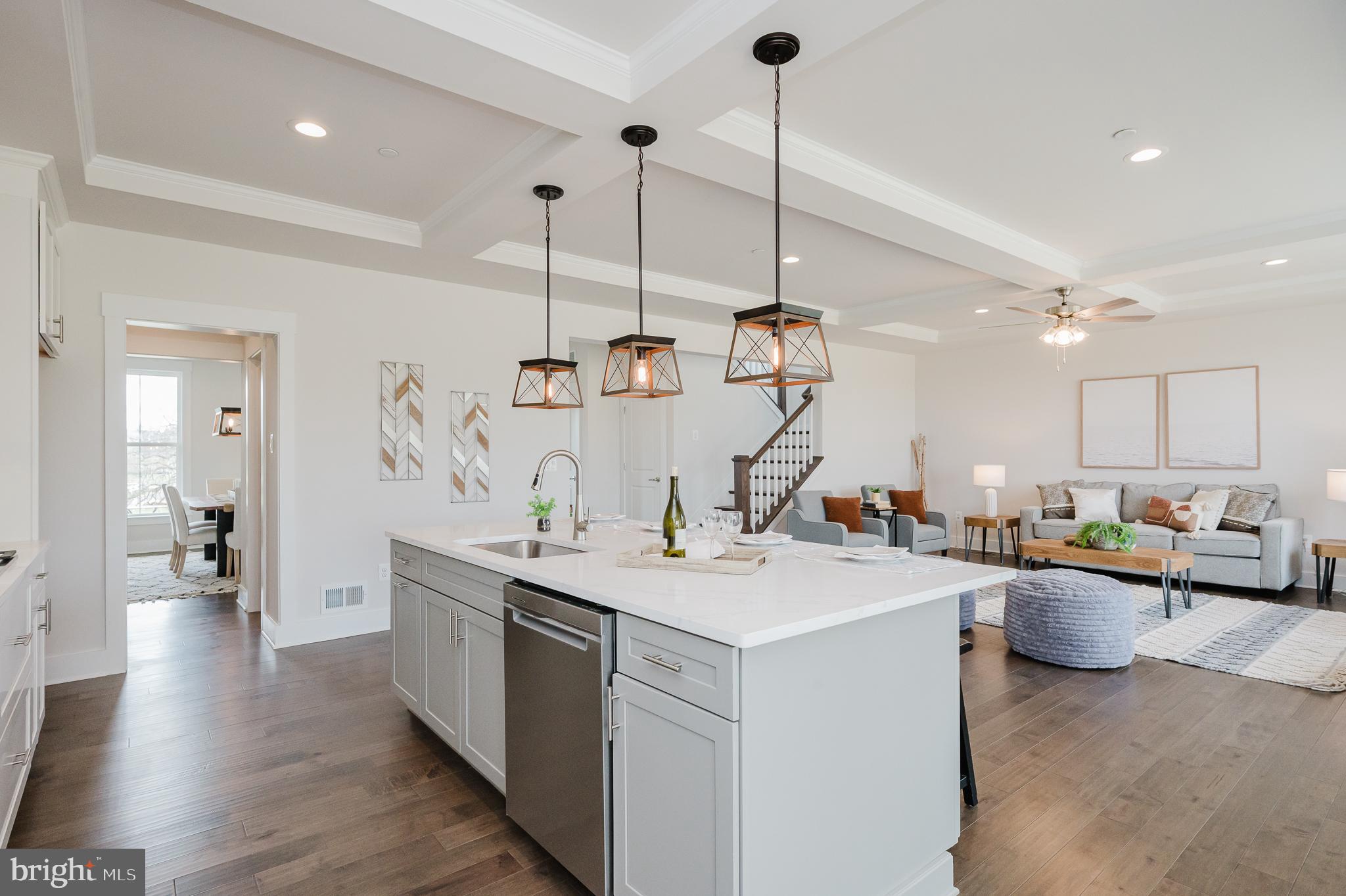 5725 Hodges Road Sykesville, MD 21784 - Photo 31 of 56 a view of a kitchen with kitchen island a sink a stove and a wooden floor