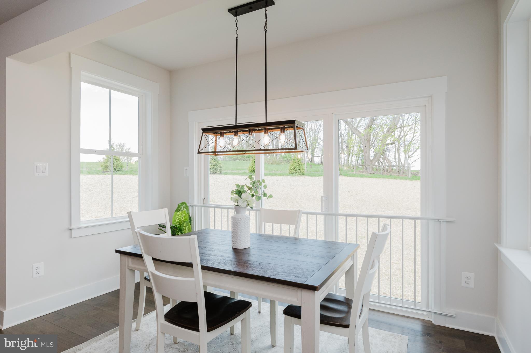 5725 Hodges Road Sykesville, MD 21784 - Photo 32 of 56 a view of a dining room with furniture a chandelier and wooden floor