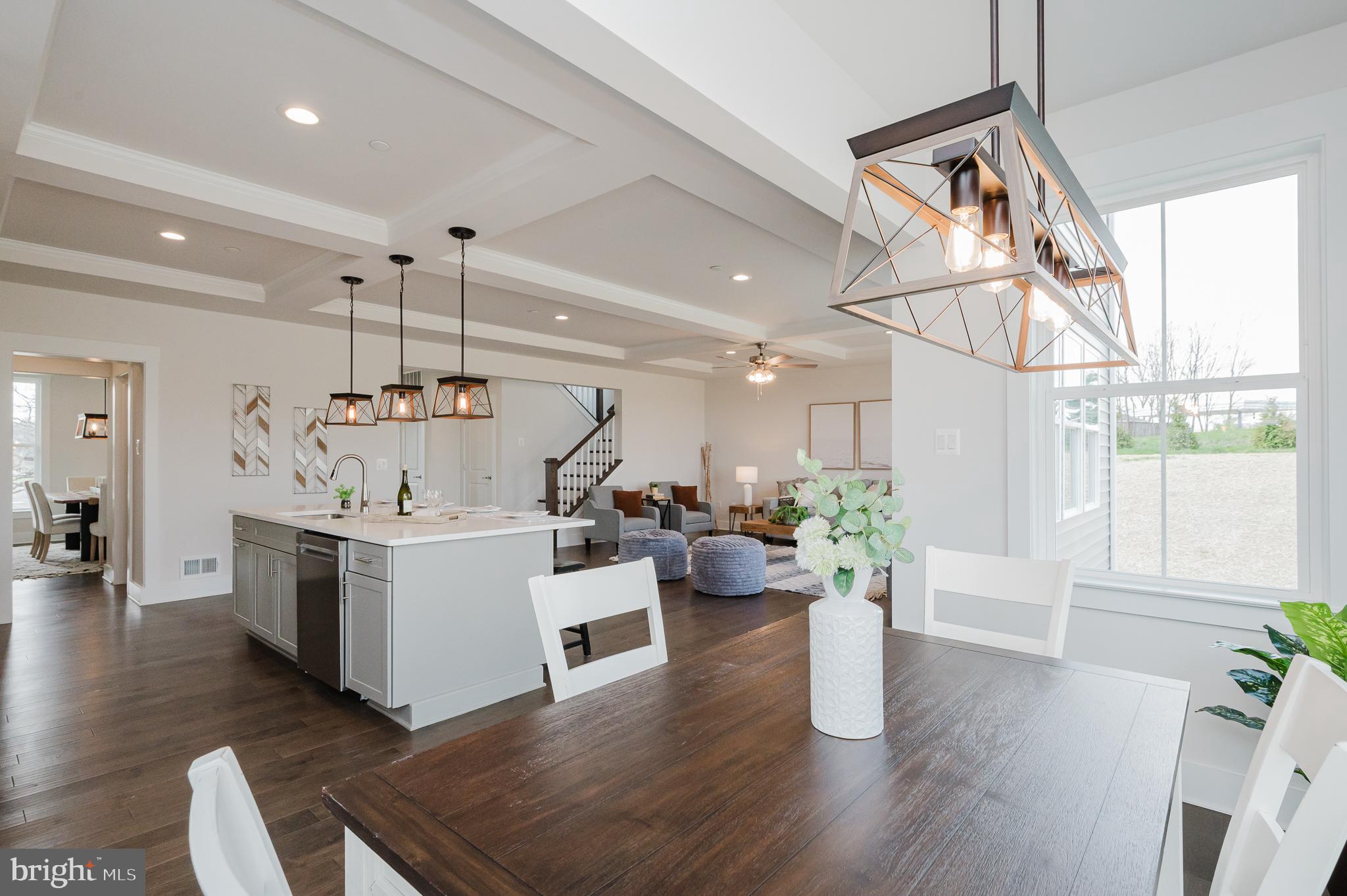 5725 Hodges Road Sykesville, MD 21784 - Photo 33 of 56 a kitchen with a sink dishwasher and a dining table with wooden floor