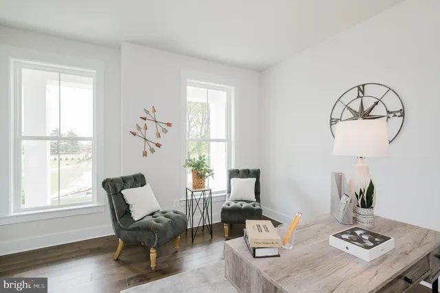a living room with furniture a table and a window