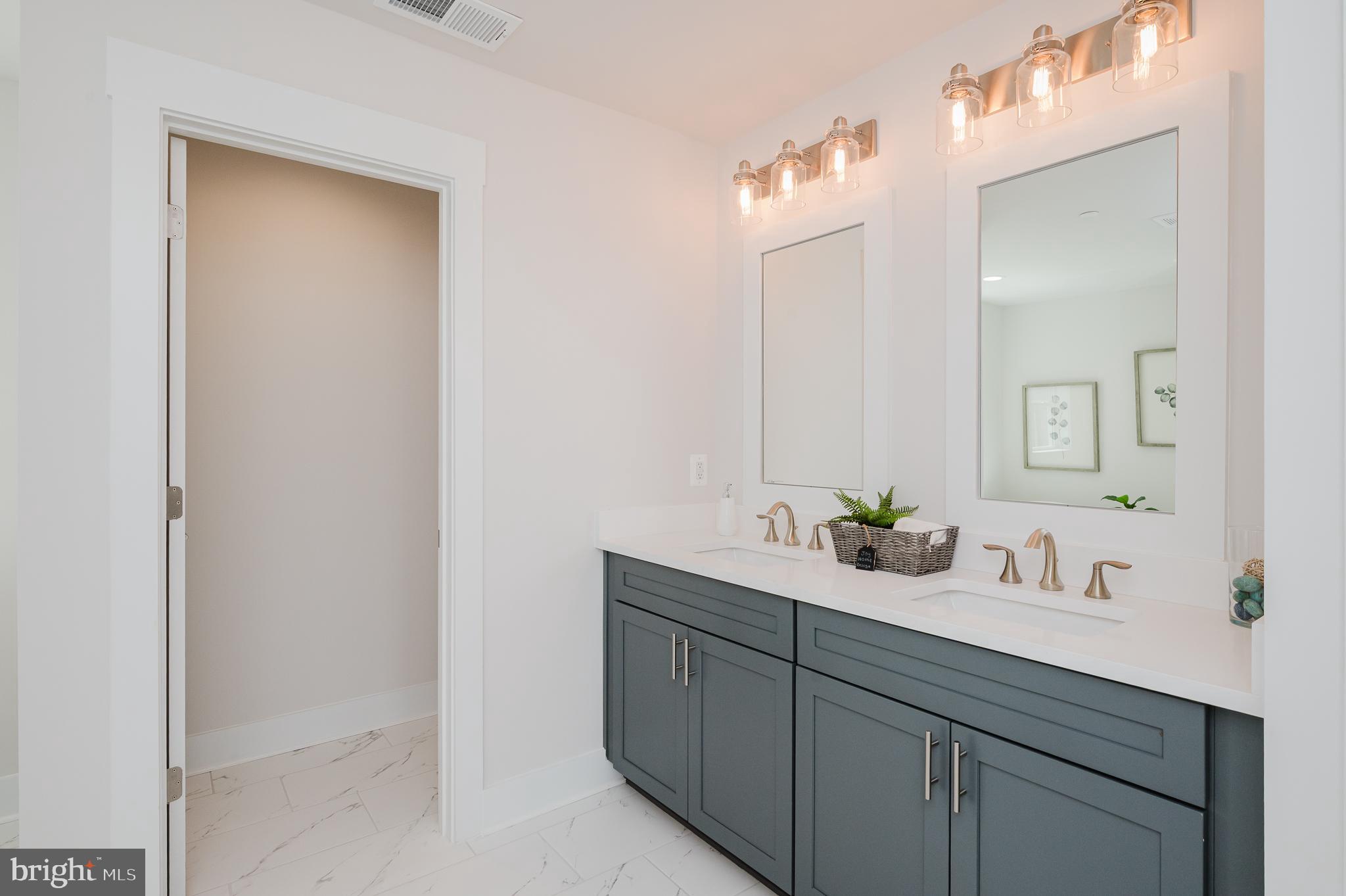 5725 Hodges Road Sykesville, MD 21784 - Photo 45 of 56 a bathroom with a double vanity sink and mirror