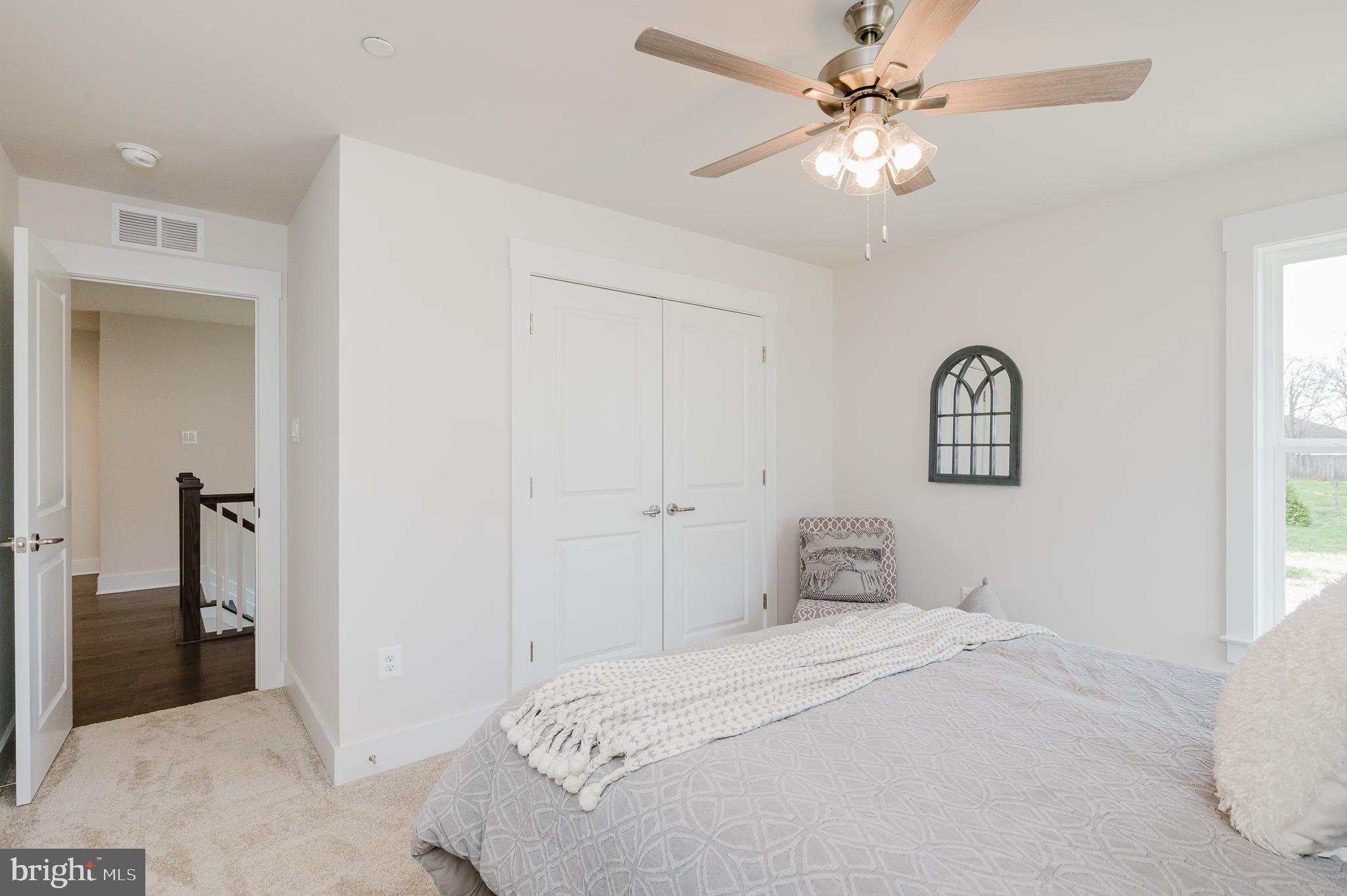 5725 Hodges Road Sykesville, MD 21784 - Photo 48 of 56 a bedroom with a bed and a chandelier