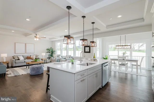 a kitchen with a sink stove and wooden floor