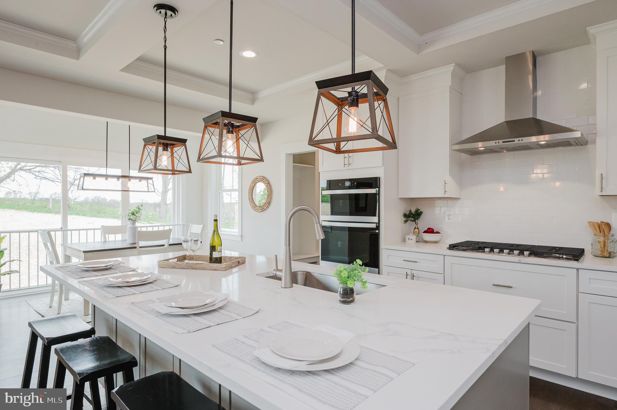 5725 Hodges Road Sykesville, MD 21784 - Photo 8 of 56 a kitchen with stainless steel appliances wooden floor dining table and chairs