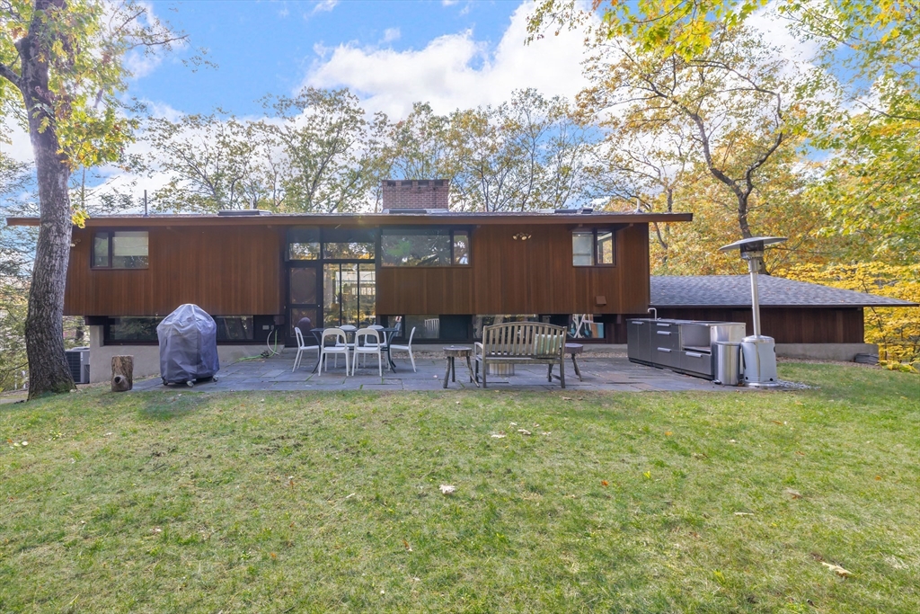 134 Rangeley Road Brookline, MA 02467 - Photo 26 of 27 a backyard of a house with table and chairs