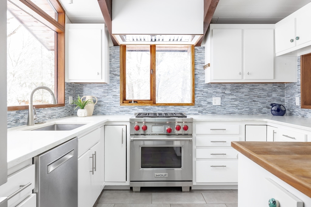 134 Rangeley Road Brookline, MA 02467 - Photo 7 of 27 a kitchen with granite countertop a sink and a stove