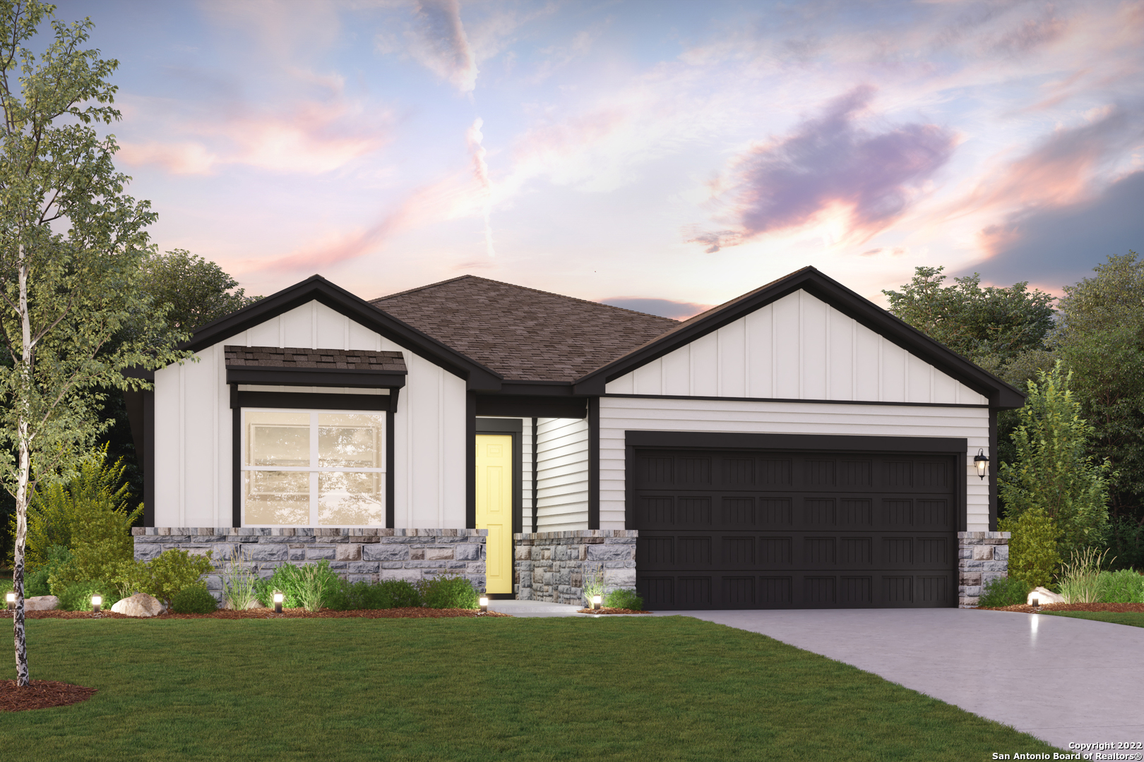 a front view of a house with a garden and yard