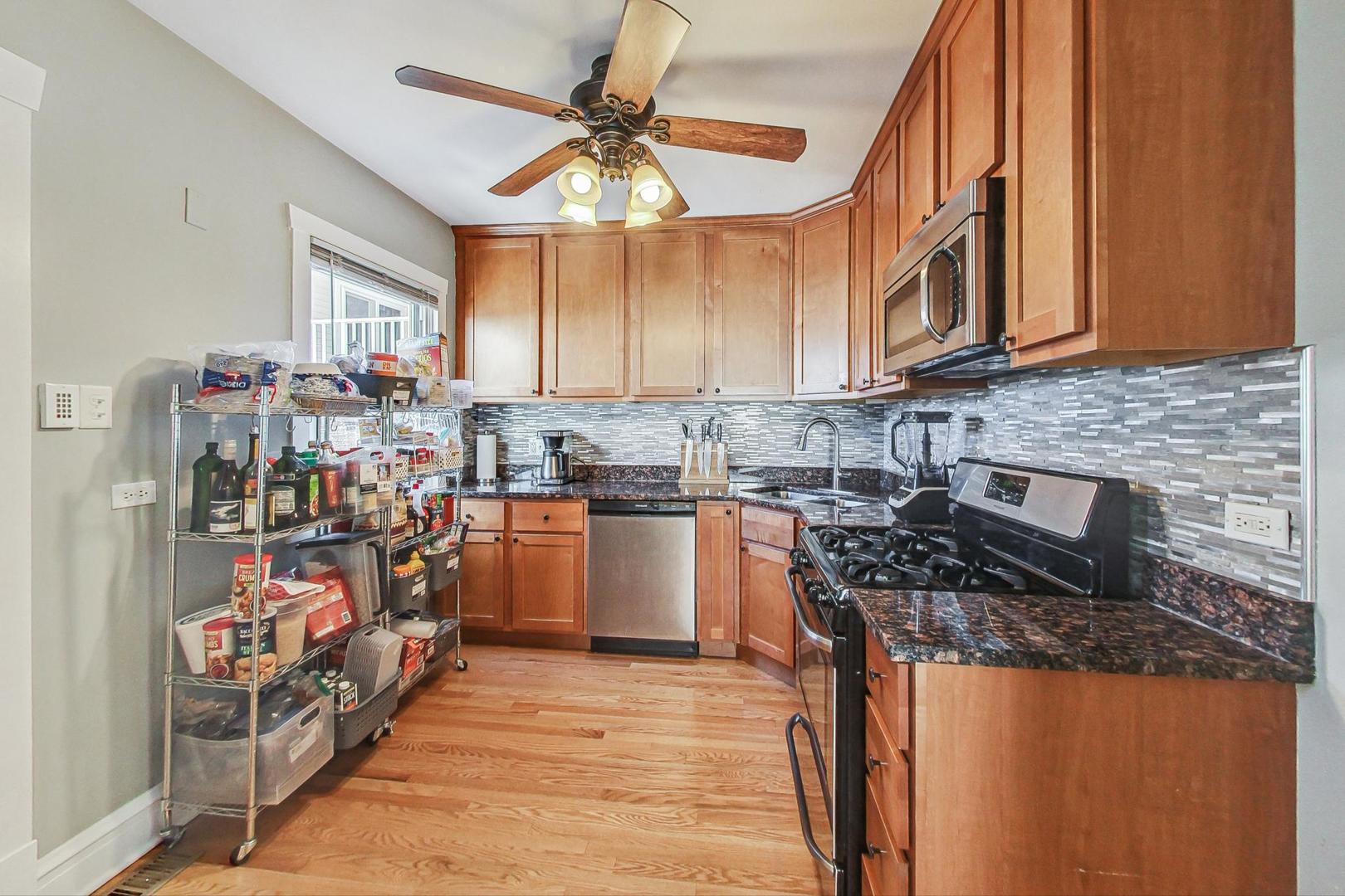 1434 Elgin Avenue Forest Park, IL 60130 - Photo 11 of 35 a kitchen with stainless steel appliances granite countertop a stove and a sink