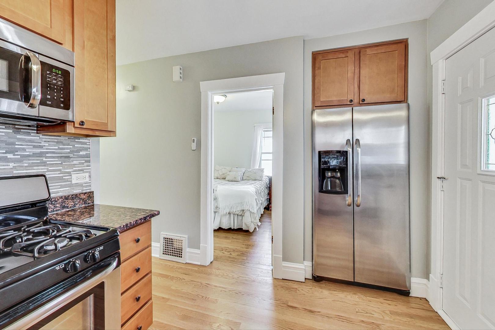 1434 Elgin Avenue Forest Park, IL 60130 - Photo 13 of 35 a kitchen with stainless steel appliances granite countertop a refrigerator and a stove top oven