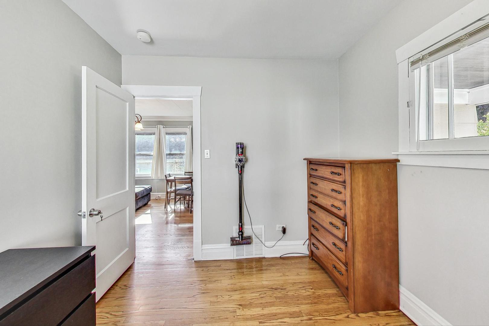 1434 Elgin Avenue Forest Park, IL 60130 - Photo 19 of 35 a view of a hallway with wooden floor and a living room