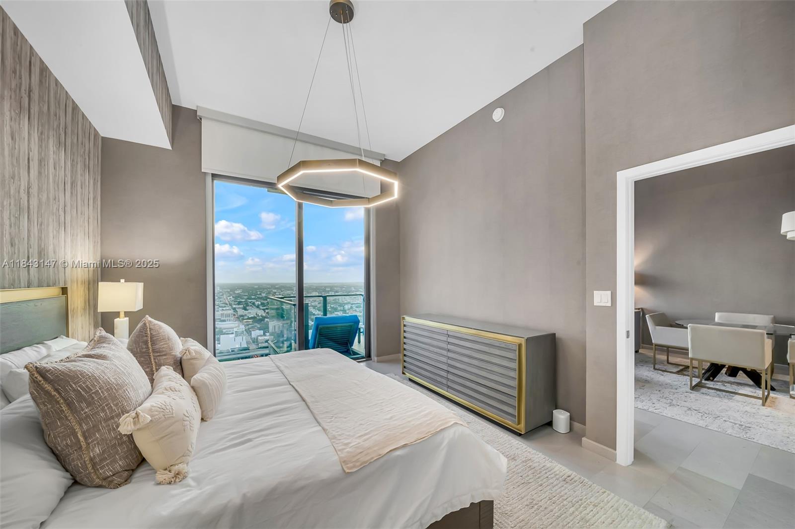 88 Southwest 7th Street, Unit 4006 Miami, FL 33130 - Photo 12 of 22 a bedroom with a bed and a chandelier