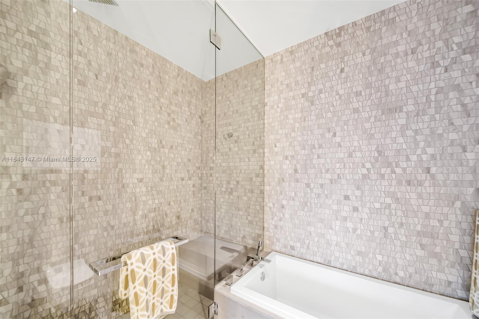 88 Southwest 7th Street, Unit 4006 Miami, FL 33130 - Photo 16 of 22 a bathroom with a bathtub and shower