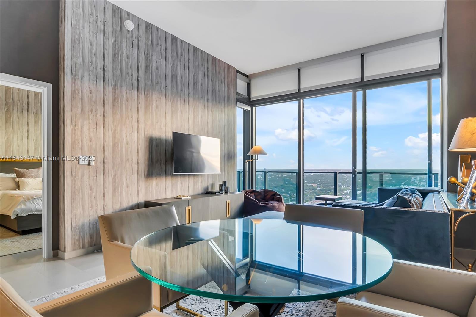 88 Southwest 7th Street, Unit 4006 Miami, FL 33130 - Photo 4 of 22 a living room with couches a coffee table and a flat screen tv