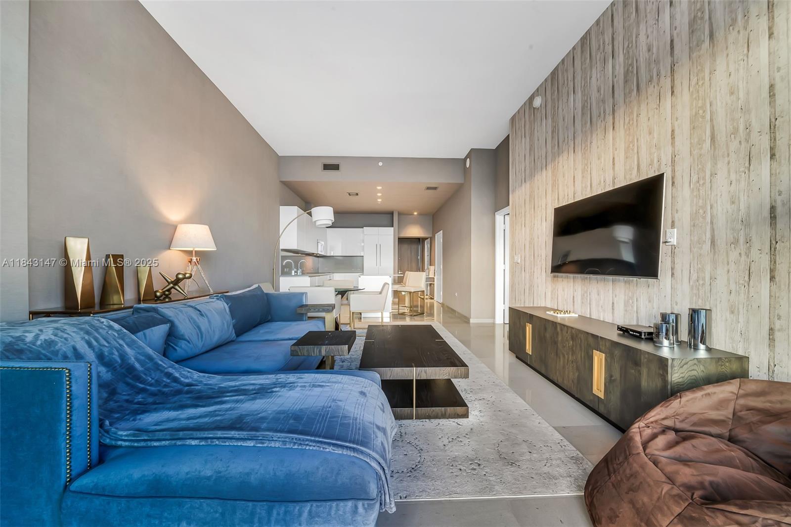 88 Southwest 7th Street, Unit 4006 Miami, FL 33130 - Photo 6 of 22 a living room with furniture and a flat screen tv