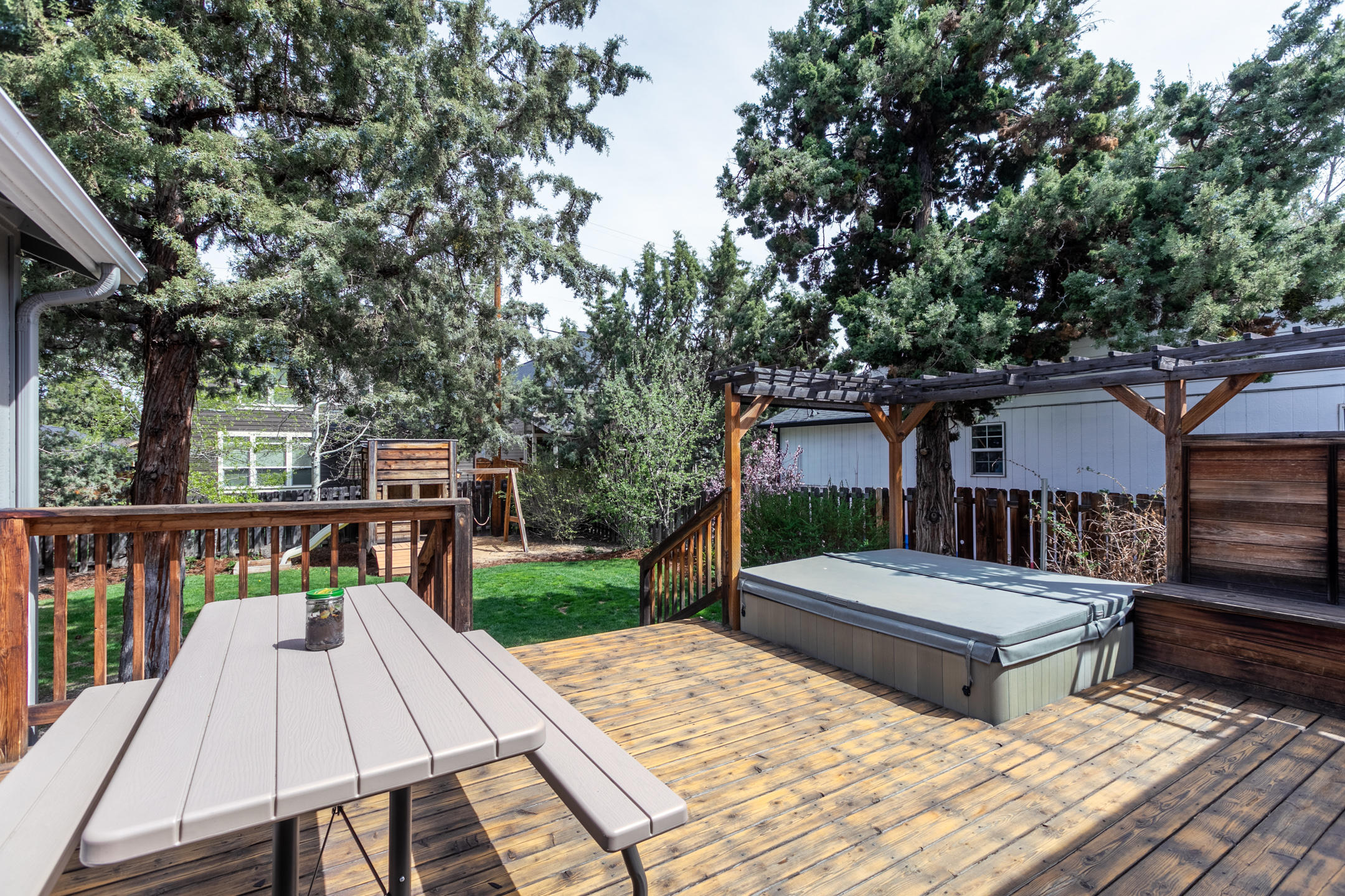 20222 Star Ridge Court Bend, OR 97703 - Photo 16 of 18 Back Deck with Hot Tub & Play Structure