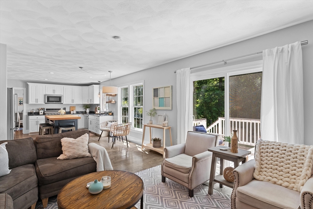 69 Curzon Mill Road Newburyport, MA 01950 - Photo 11 of 40 a living room with furniture and a large window