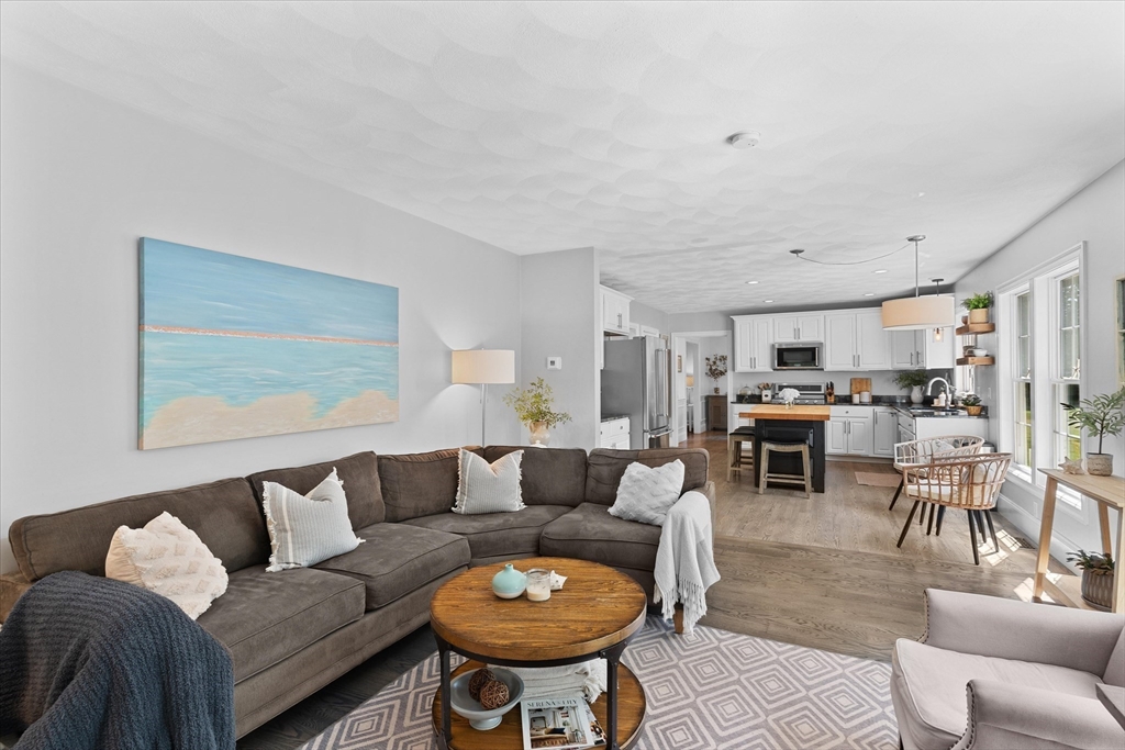 69 Curzon Mill Road Newburyport, MA 01950 - Photo 12 of 40 a living room with furniture a rug and kitchen view