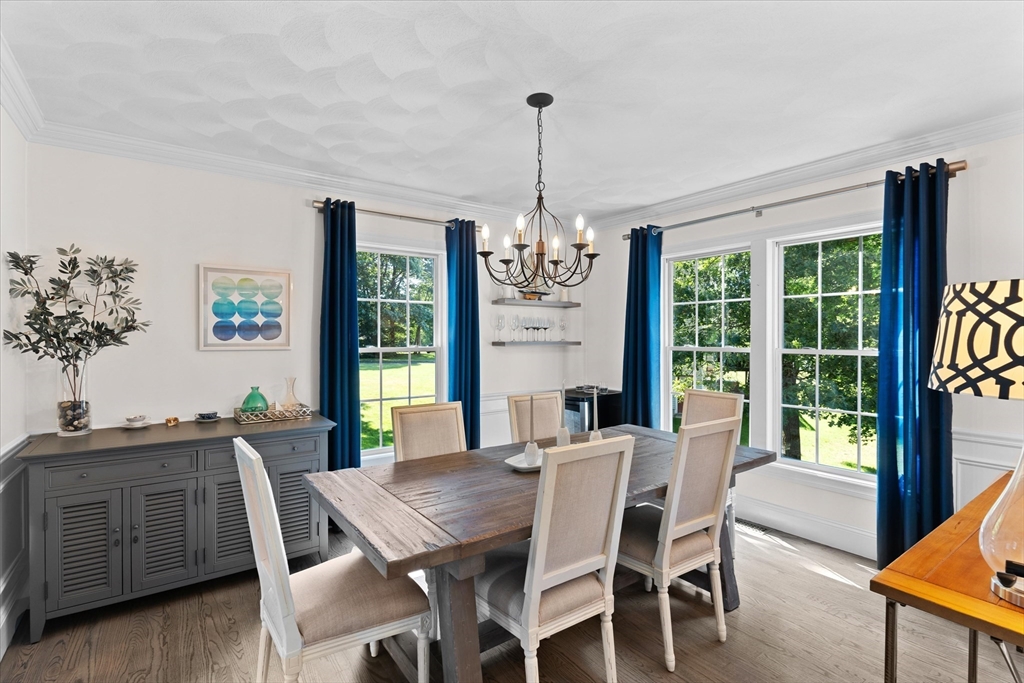 69 Curzon Mill Road Newburyport, MA 01950 - Photo 15 of 40 a view of a dining room with furniture window and wooden floor