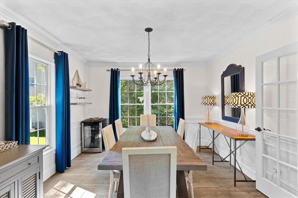 69 Curzon Mill Road Newburyport, MA 01950 - Photo 16 of 40 a dining room with furniture a chandelier and wooden floor
