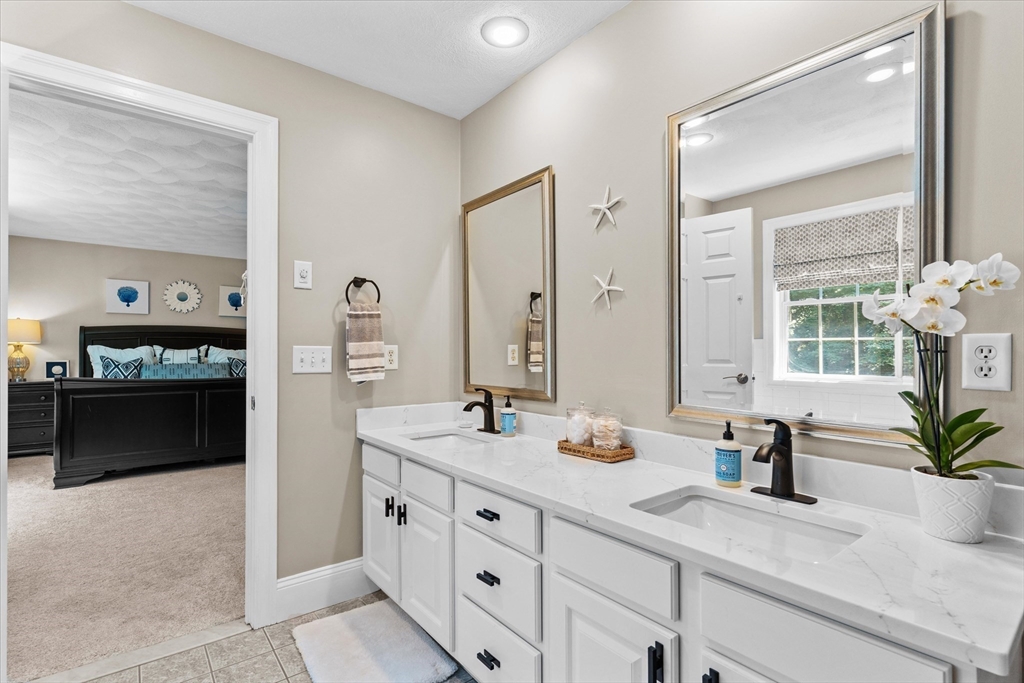 69 Curzon Mill Road Newburyport, MA 01950 - Photo 24 of 40 a spacious bathroom with double sink and a mirror