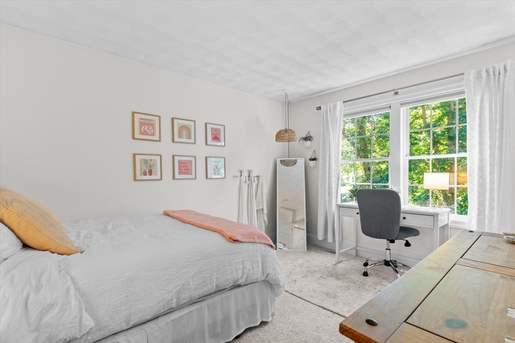 69 Curzon Mill Road Newburyport, MA 01950 - Photo 29 of 40 a bedroom with a bed and glass window