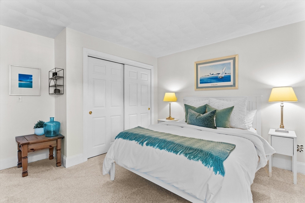 69 Curzon Mill Road Newburyport, MA 01950 - Photo 31 of 40 a bedroom with a bed and a lamp on table