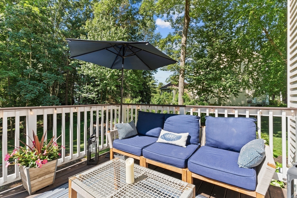 69 Curzon Mill Road Newburyport, MA 01950 - Photo 35 of 40 a roof deck with a table and chairs under an umbrella