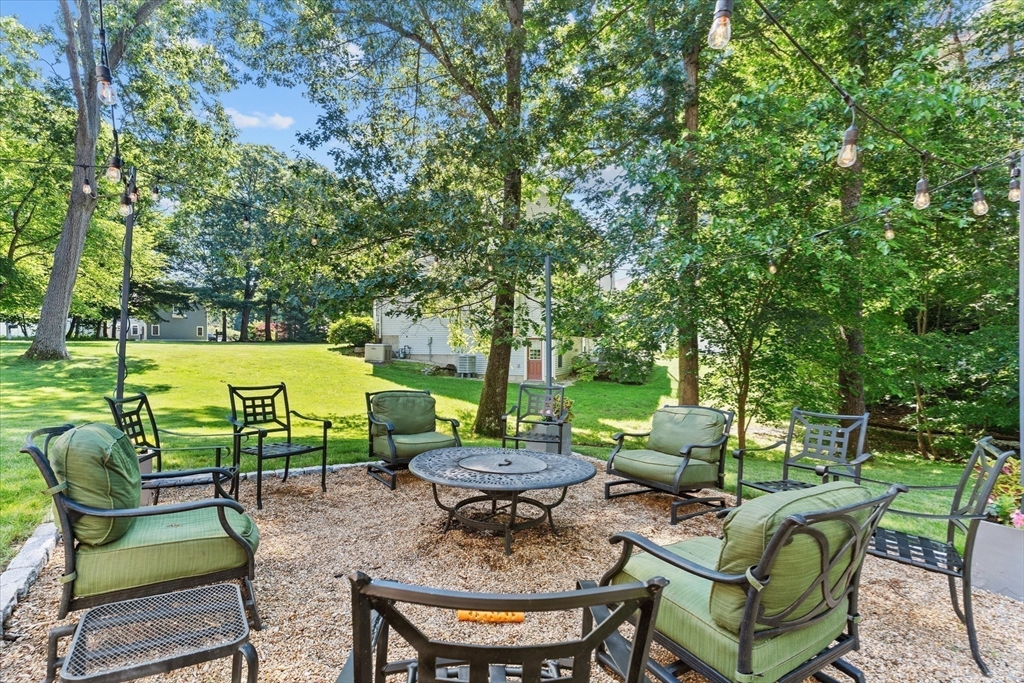 69 Curzon Mill Road Newburyport, MA 01950 - Photo 36 of 40 a view of a chairs and table in patio next to a yard