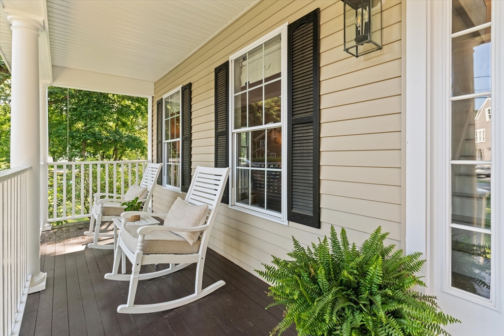 69 Curzon Mill Road Newburyport, MA 01950 - Photo 4 of 40 a balcony with table and chairs and potted plants