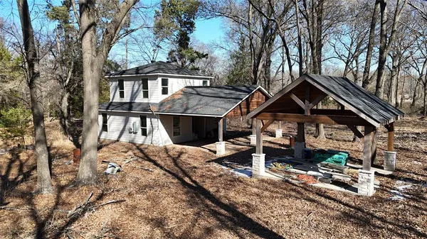 a front view of a house with a yard covered with snow in front of house