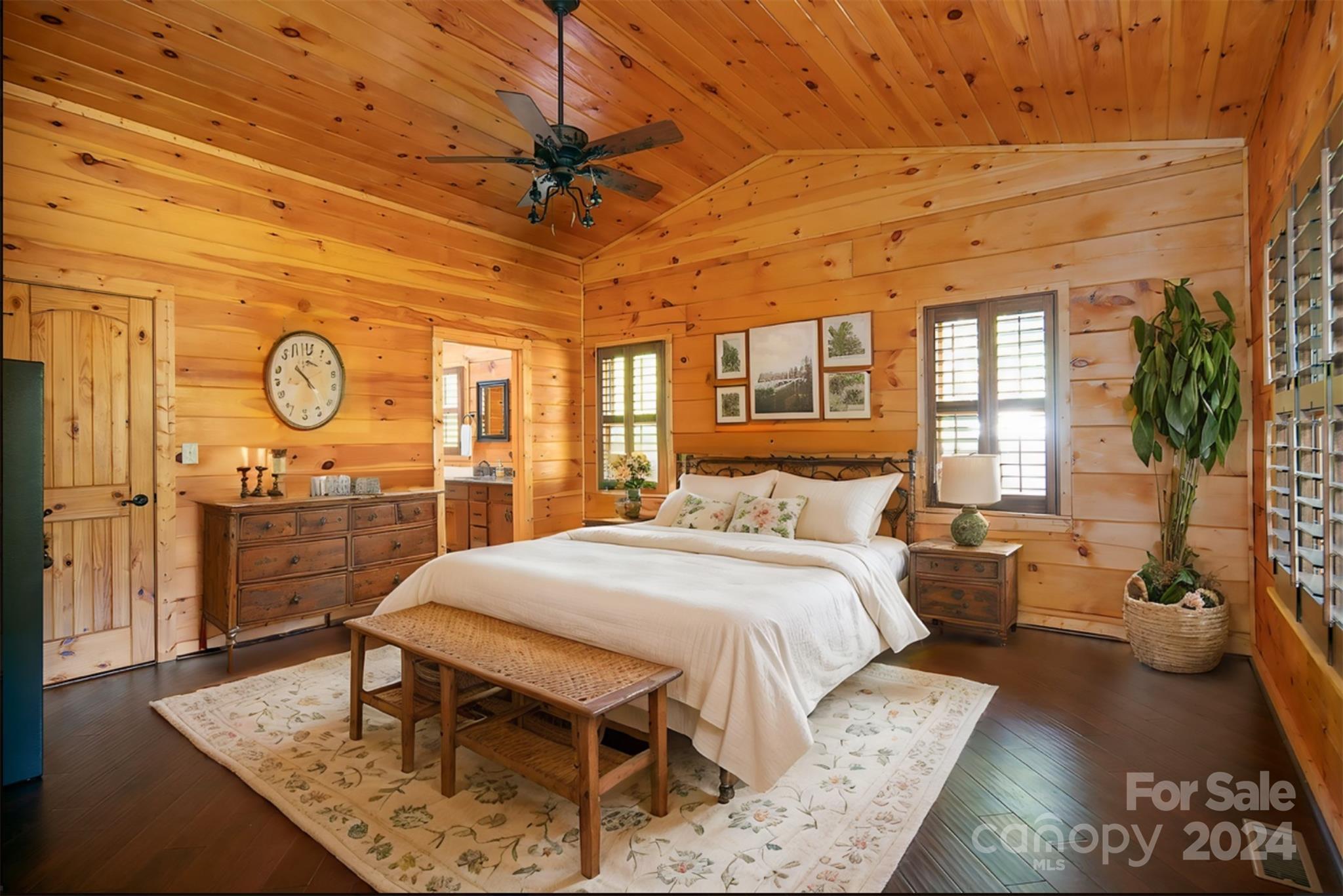 303 Lakeview Road Mocksville, NC 27028 - Photo 19 of 47 a bedroom with a bed a table and potted plant
