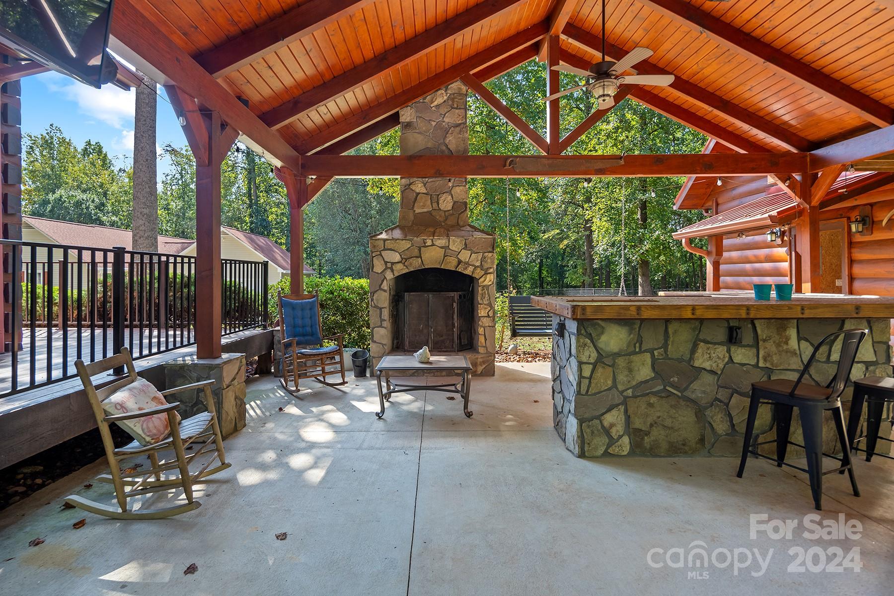 303 Lakeview Road Mocksville, NC 27028 - Photo 29 of 47 a view of a patio with table and chairs under an umbrella with a small yard