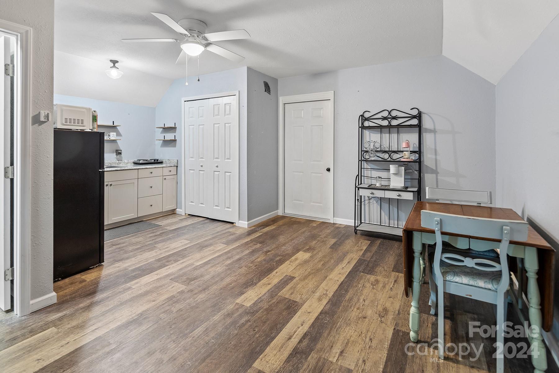 303 Lakeview Road Mocksville, NC 27028 - Photo 32 of 47 a kitchen with a refrigerator and a wooden cabinets