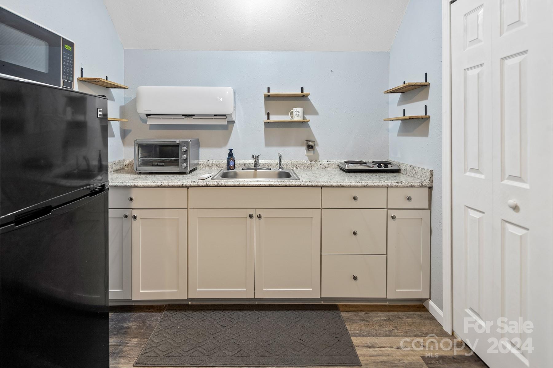 303 Lakeview Road Mocksville, NC 27028 - Photo 33 of 47 a kitchen with white cabinets and appliances